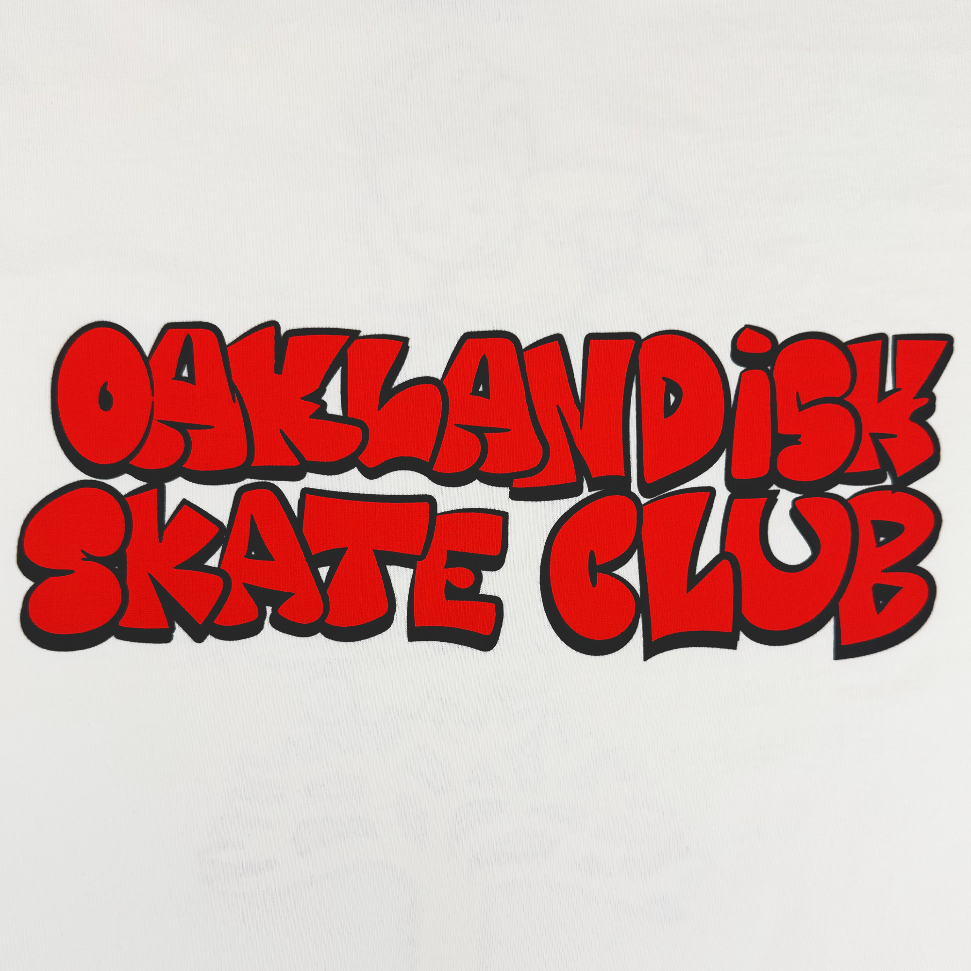 Bold red graffiti-style text reading “OAKLANDISH SKATE CLUB” with black outlines pops against a white background, capturing skateboard culture and playful energy on the classic-fit Oaklandish Skate Club Tee by Oaklandish.