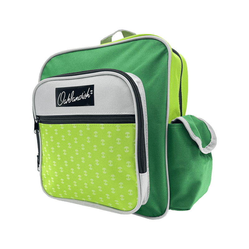Side view of primary school backpack in green, and grey with black Oaklandish logo patch with zippered front pouch & side pocket.