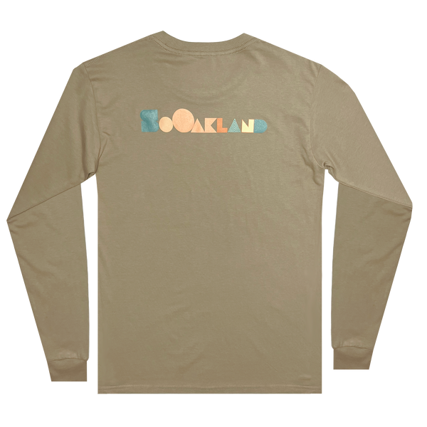The backside of a sand-colored long-sleeved t-shirt with full-color SOOAKLAND graphic wordmark.