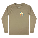 Front view of sand-colored long-sleeved t-shirt with full-color SOOAKLAND graphic wordmark on left wear side chest 