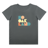 Front view of charcoal toddler t-shirt with full-color SOOAKLAND graphic wordmark on front chest.