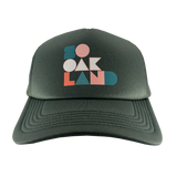Front view of a cypress green trucker cap with full-color SoOakland wordmark in the crown.