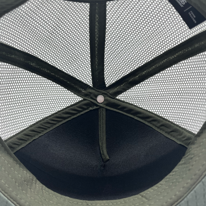 View the mesh crown's underside on a cypress green truckers cap.