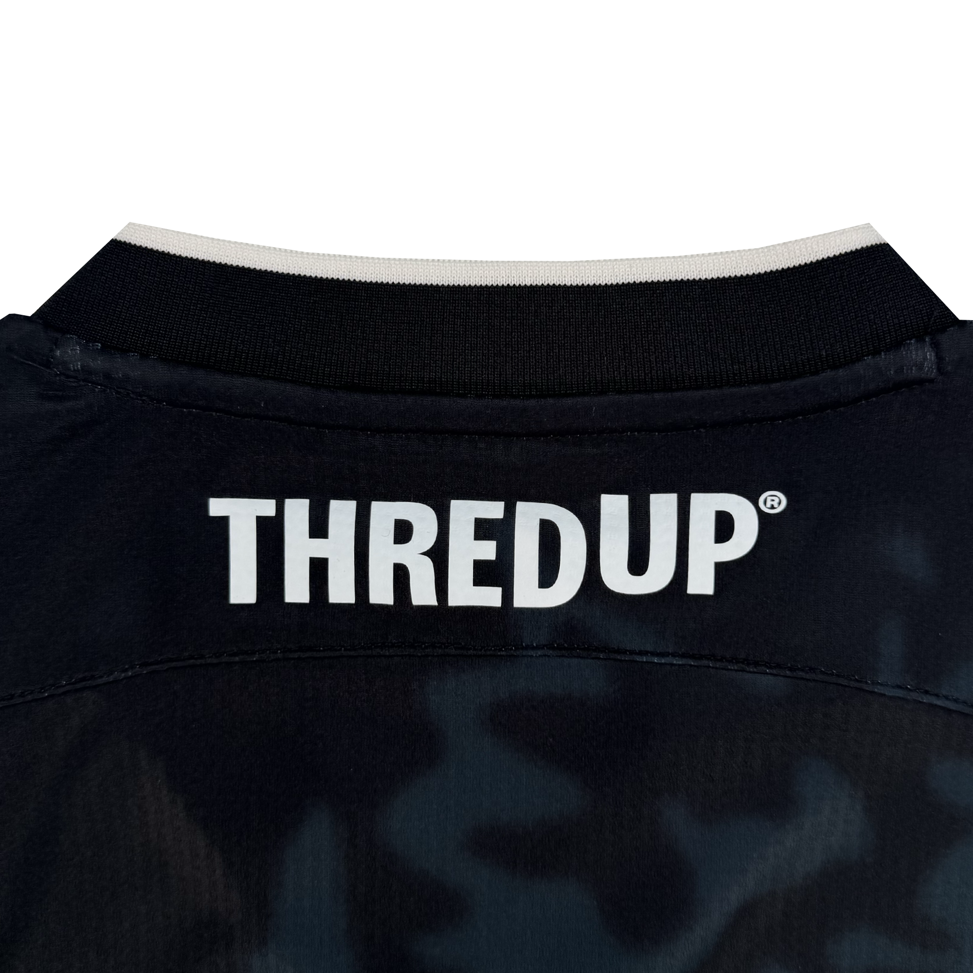 Close-up of the upper back of an Oakland Soul Custom The Soul Bloom Kit with a black collar and white trim. "THREDUP" is printed in bold white letters on subtly patterned fabric. Pre-order for custom name and number options.