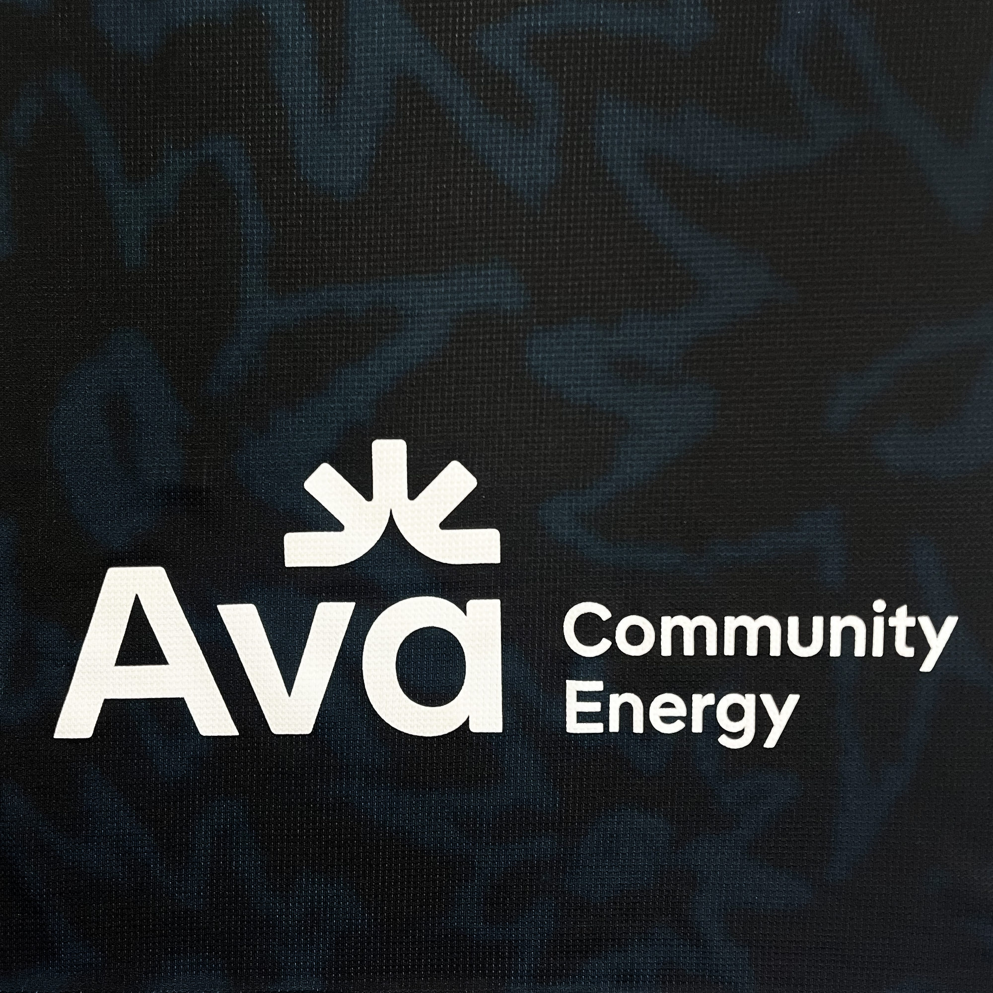 Detailed back view of Ava community energy logo on the back of Oakland Soul black jersey.