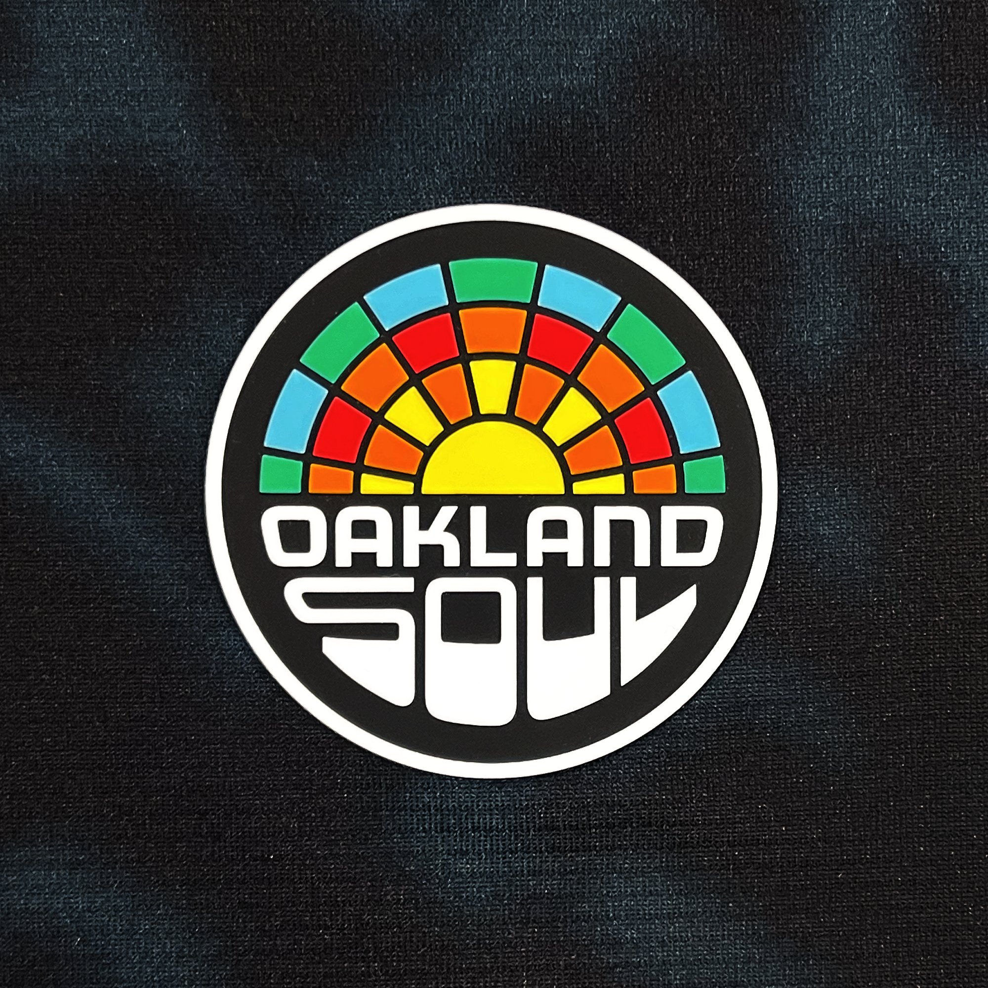Detailed view of Oakland Soul crest on black unisex Oakland Soul SC Home jersey.