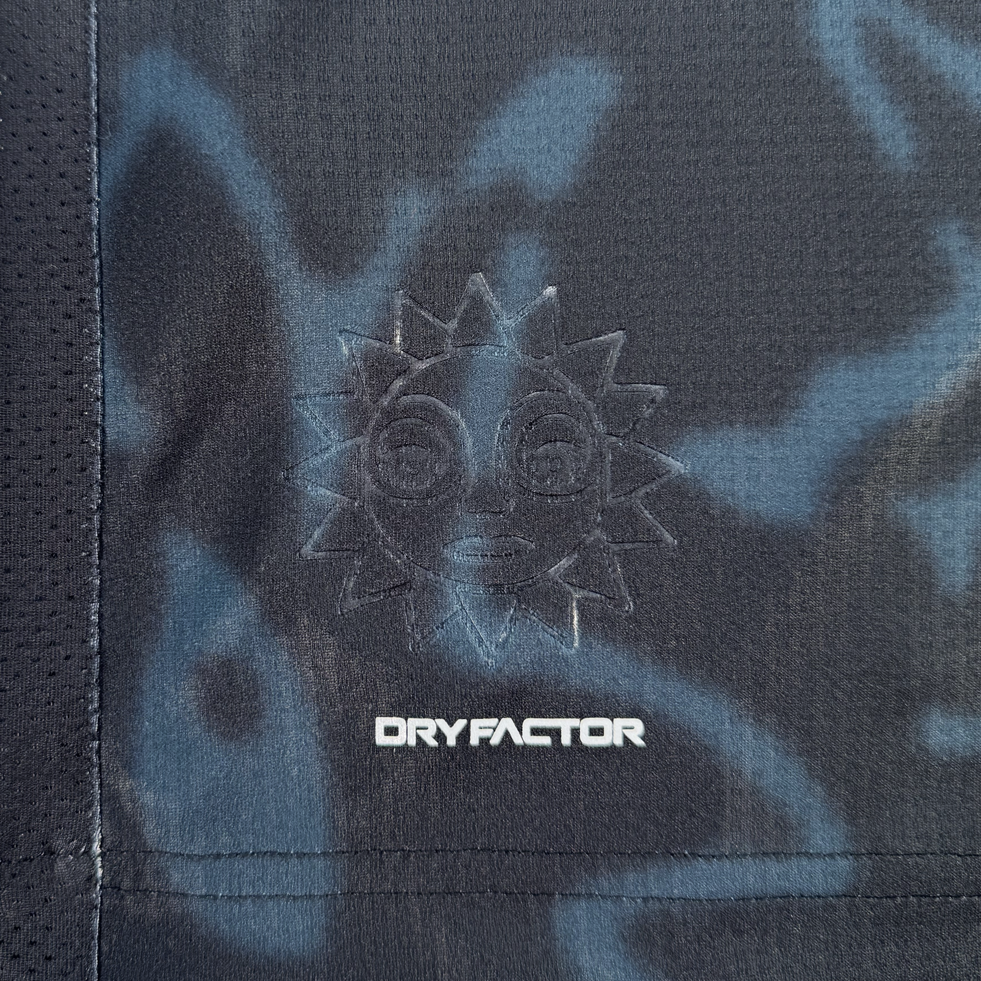 Close-up of dark Oakland Soul fabric with a subtle blue pattern. An embroidered sun with a face sits above "DRYFACTOR." The sporty, textured Custom The Soul Bloom Kit can feature your custom name and number. Pre-order now!.