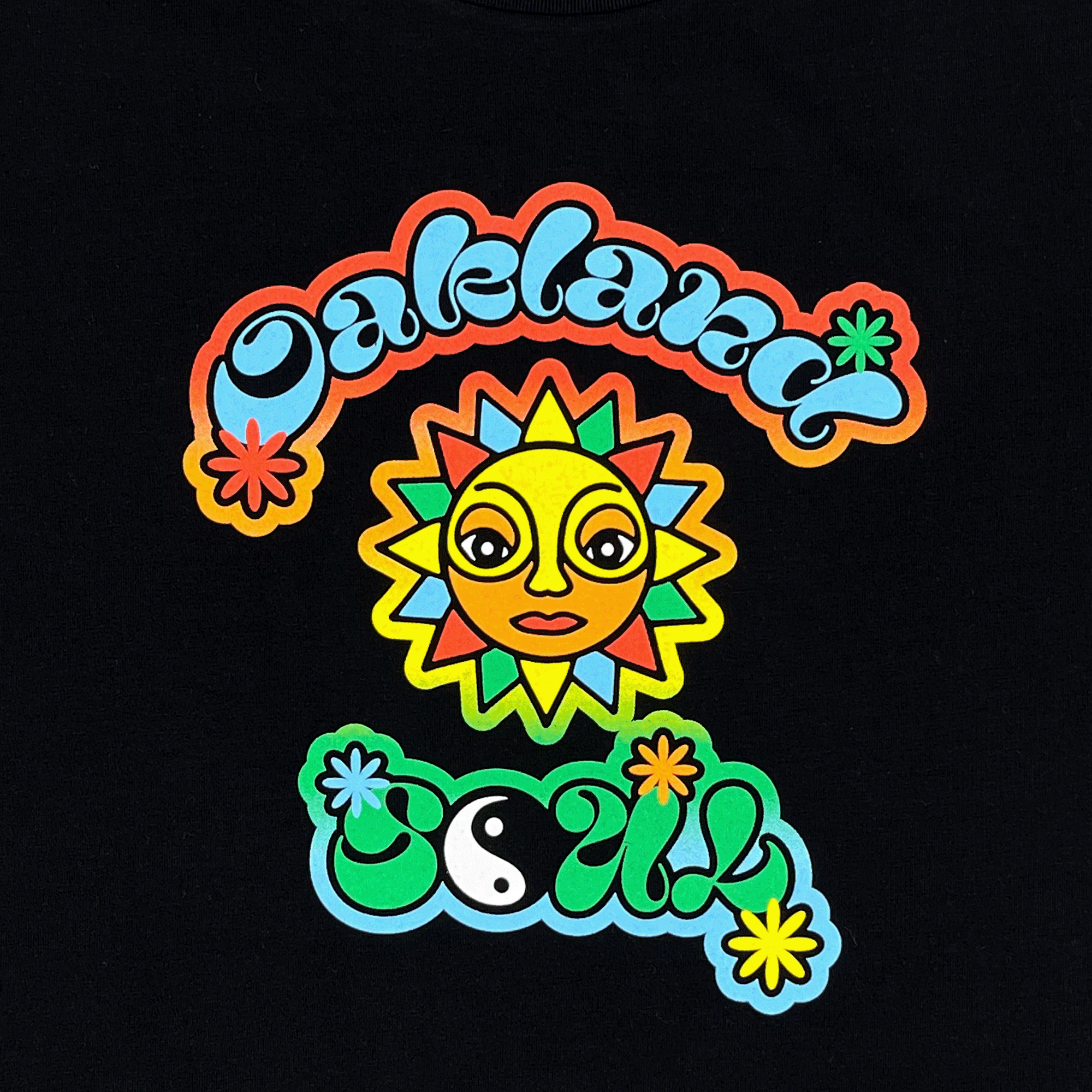The Women's Soul of the Town Tee by Other showcases "Oakland Soul" in psychedelic lettering celebrating women's soccer. The word "Oakland" arches above with a sun face, while "Soul" features a green and blue yin-yang below. Colorful star-like flowers complete the USL W-League design on black.