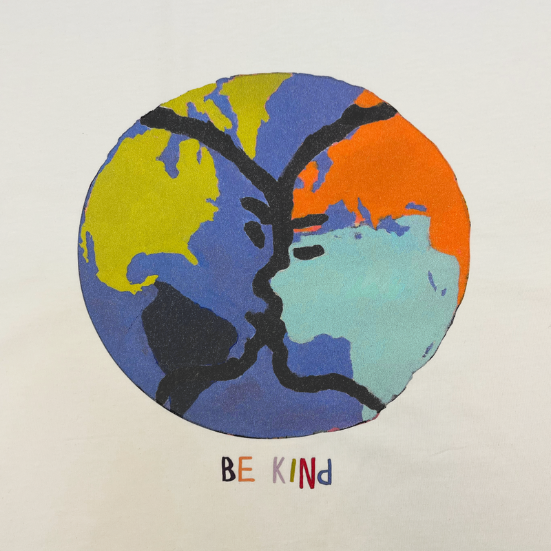Close-up of the Be Kind Oakland mural art graphic by contemporary artist Squeak Carnwath on a natural cotton colored t-shirt.