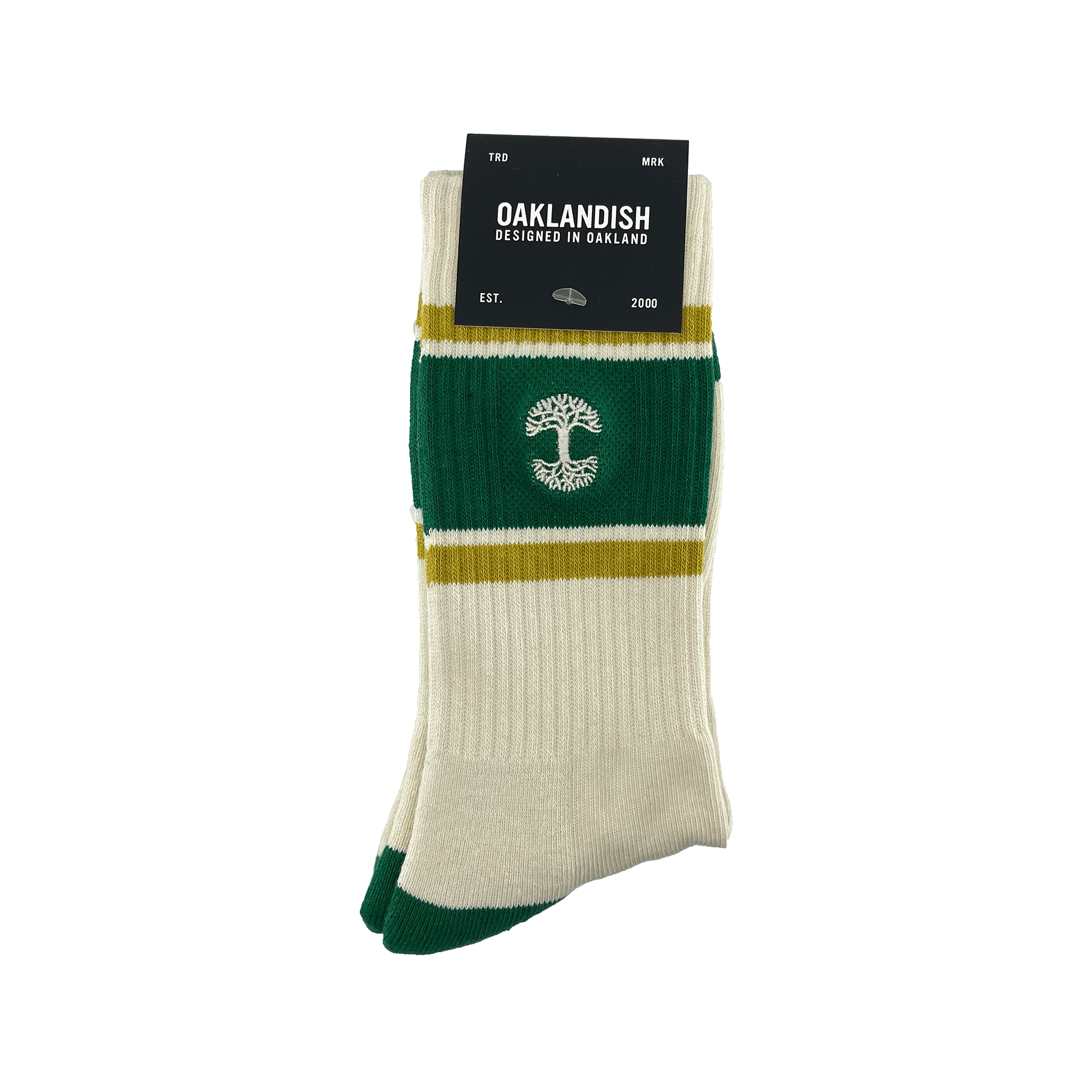 A brand new pair of Striped Classic Socks from Oaklandish, designed in a cream and green color palette with mustard yellow stripes, is neatly folded and adorned with a black cardboard tag. Made from 70% cotton, these crew socks feature a distinctive white tree emblem in the center. The tag reads "Oaklandish, Designed in Oakland," followed by "EST." and "2000." They are presented against a white background.