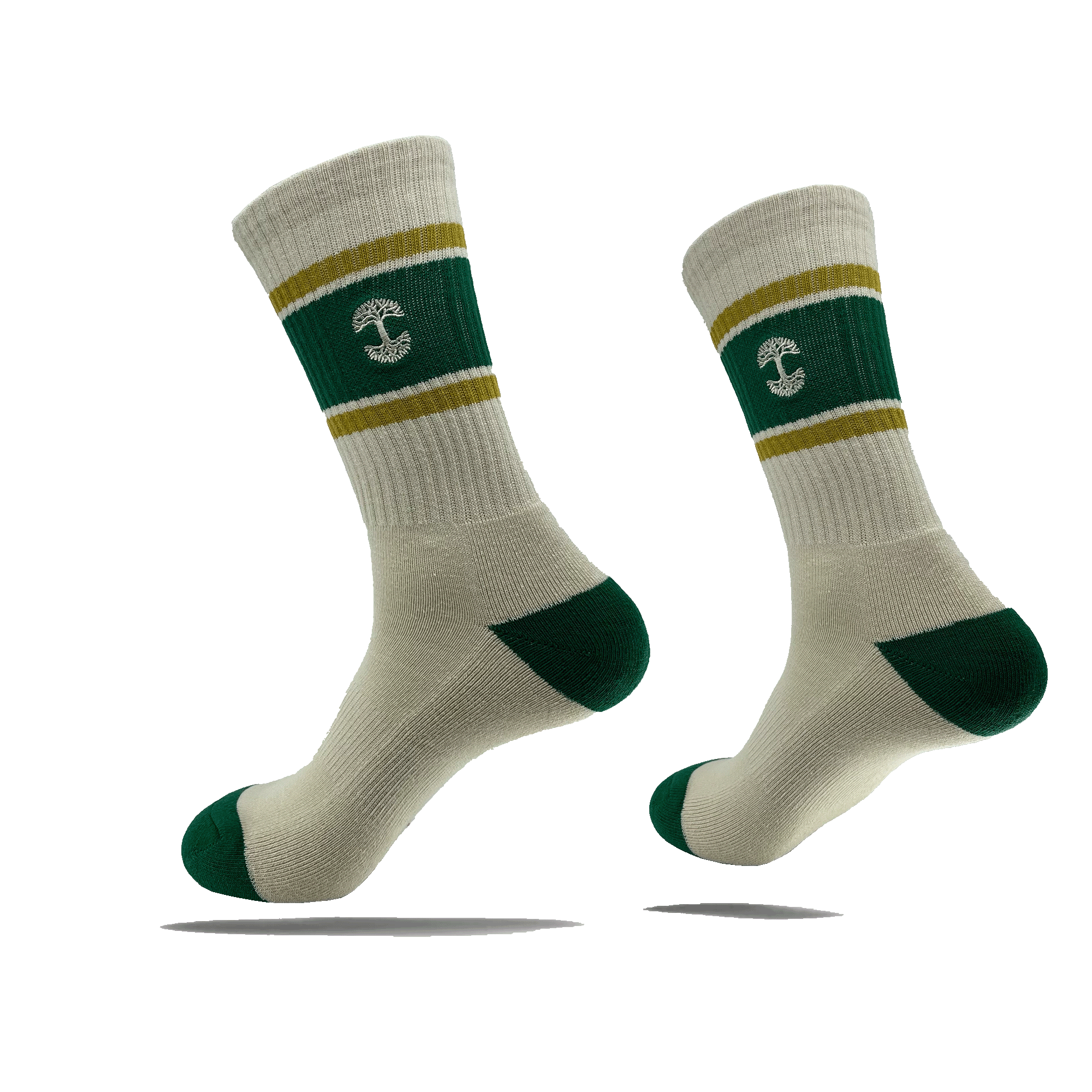 Introducing the Striped Classic Sock by Oaklandish: a pair of beige crew socks featuring green heels, toes, and cuffs. The socks sport a green band around the lower leg area, accented with two thin yellow stripes above and below it. At the center of this green band is a white anchor symbol. Crafted from 70% cotton, these stylish socks are available in adult sizes. They are showcased suspended in mid-air against a plain green background.