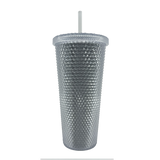 The backside of a silver-studded Oaklandish bling travel tumbler with lid and straw.