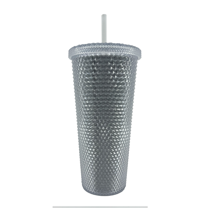 The backside of a silver-studded Oaklandish bling travel tumbler with lid and straw.