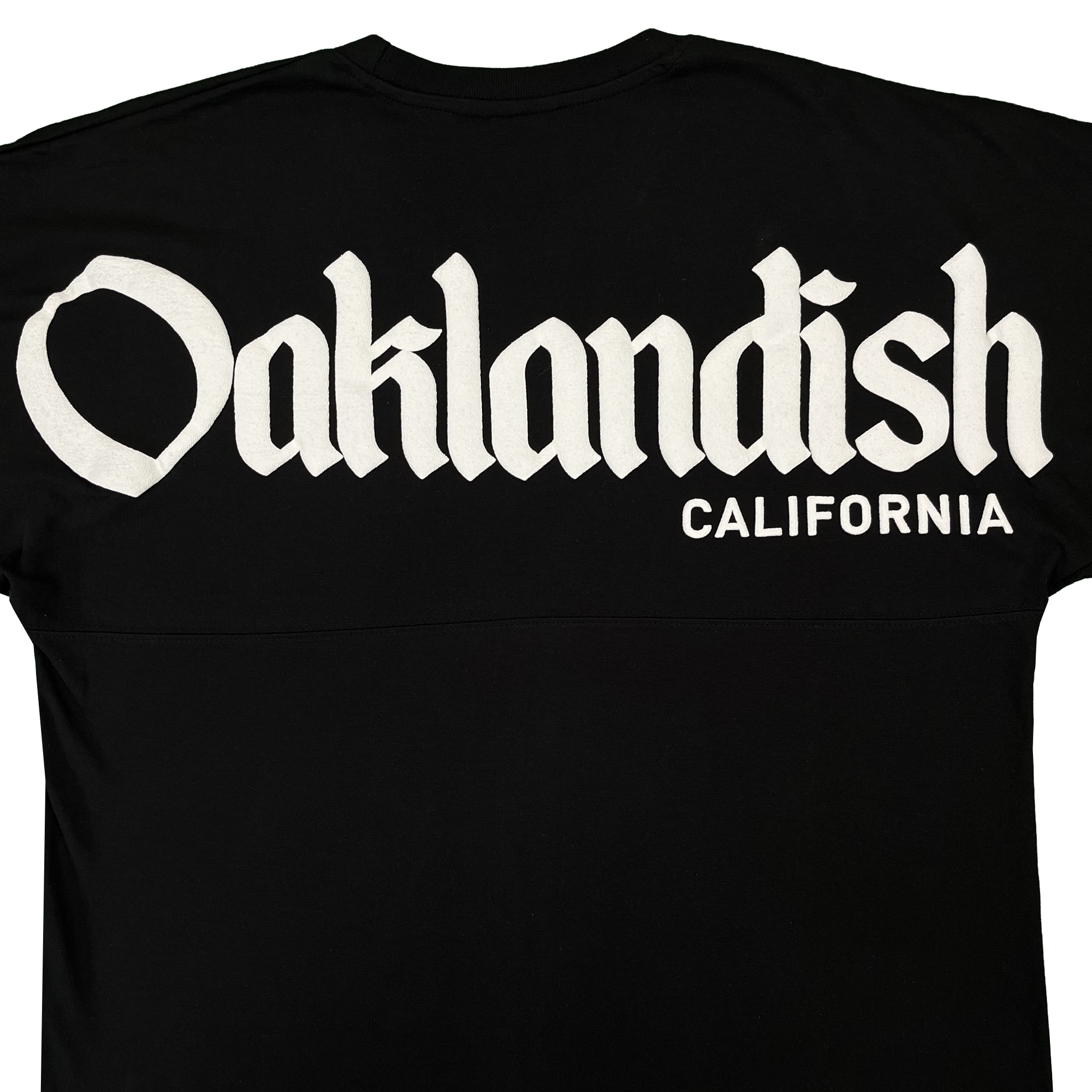A black Oaklandish Temple LS Tee for men, made from 100% cotton, features large white Old English “Oaklandish” lettering across the upper back with “California” printed in smaller plain white text below and to the right. The shirt is displayed against a clean white background.