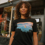 Woman wearing Oaklandish  Temple Swirl black t-shirt.