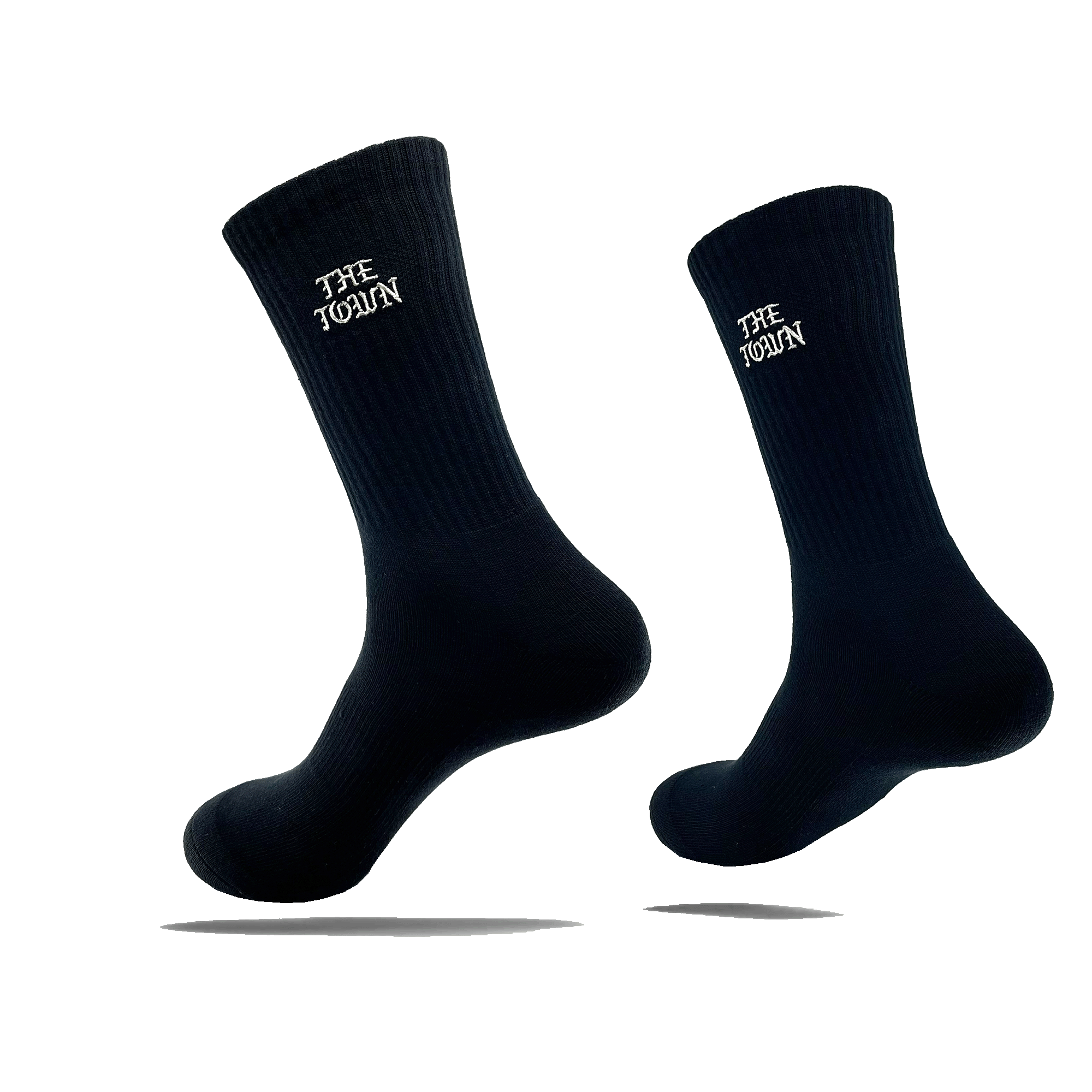 Side view of black crew socks with embroidered white THE TOWN wordmark in Old Town English on the calves.