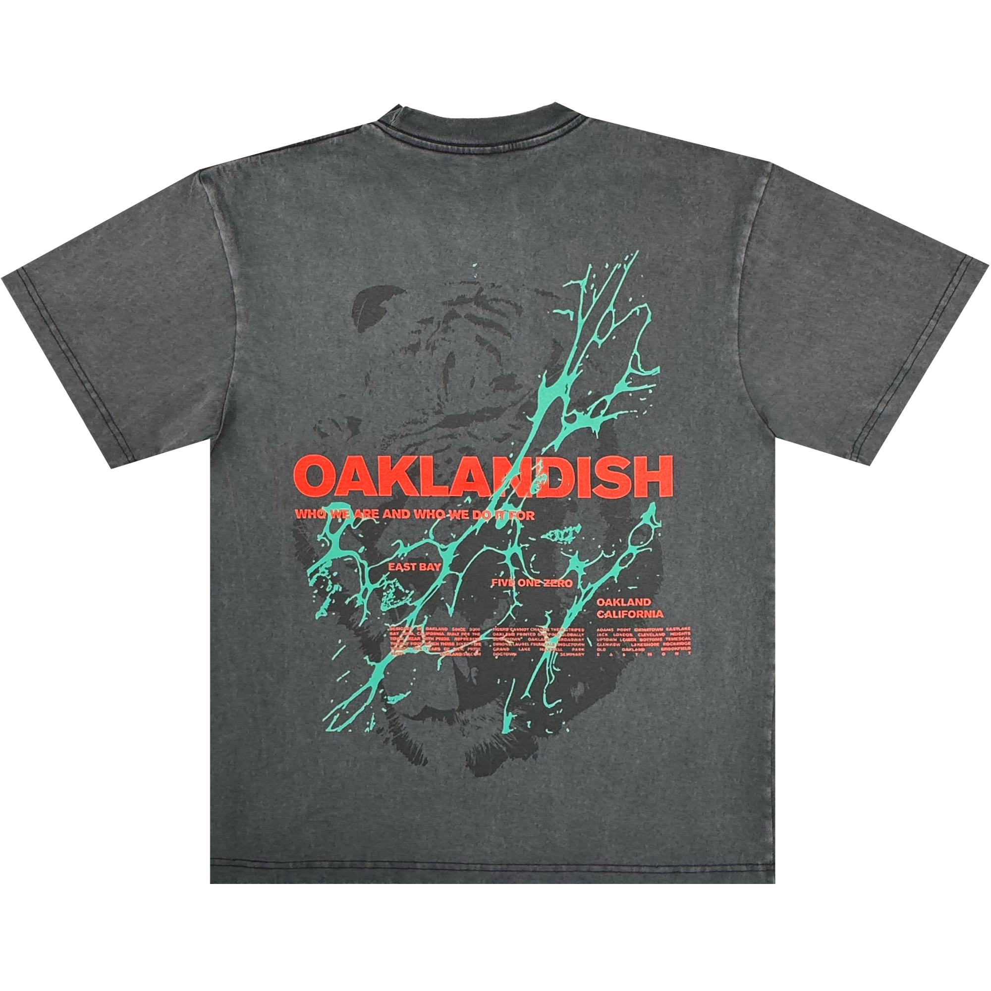 The Oaklandish Tiger Blood Tee is a vintage black 100% cotton shirt with bold red “OAKLANDISH” text across the back, a stylized black bear, teal paint splatters, and smaller white and red dates plus “Oakland, California” below.