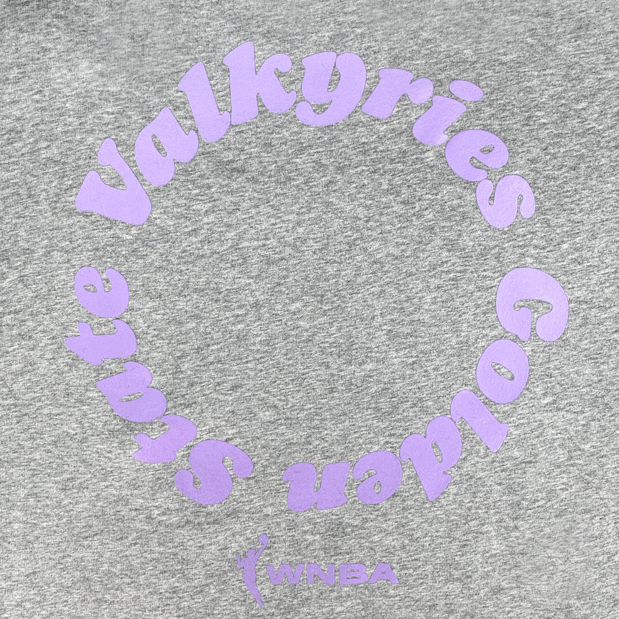 The GSV Golden State Valkyries Circle Lock Up Crew is a heather gray heavyweight fleece sweatshirt with lavender circular "Golden State Valkyries" text, the WNBA logo, and "WNBA" below in matching lavender.