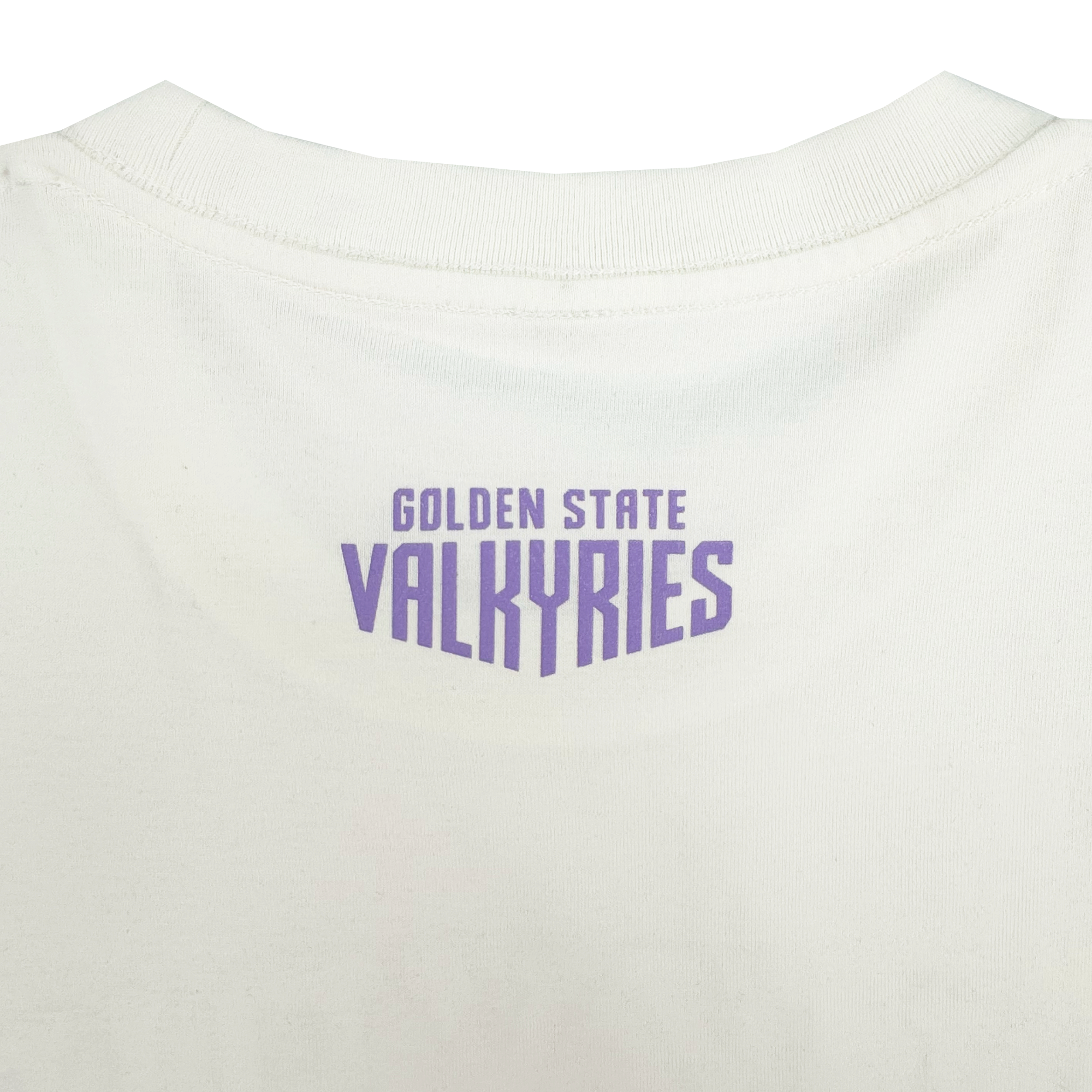 A close-up of the GSV Golden State Valkyries Rec League Tee shows “GOLDEN STATE” in small purple text above “VALKYRIES,” which appears bold and stylized, on the back neckline. Made from organic cotton heavy fabric.