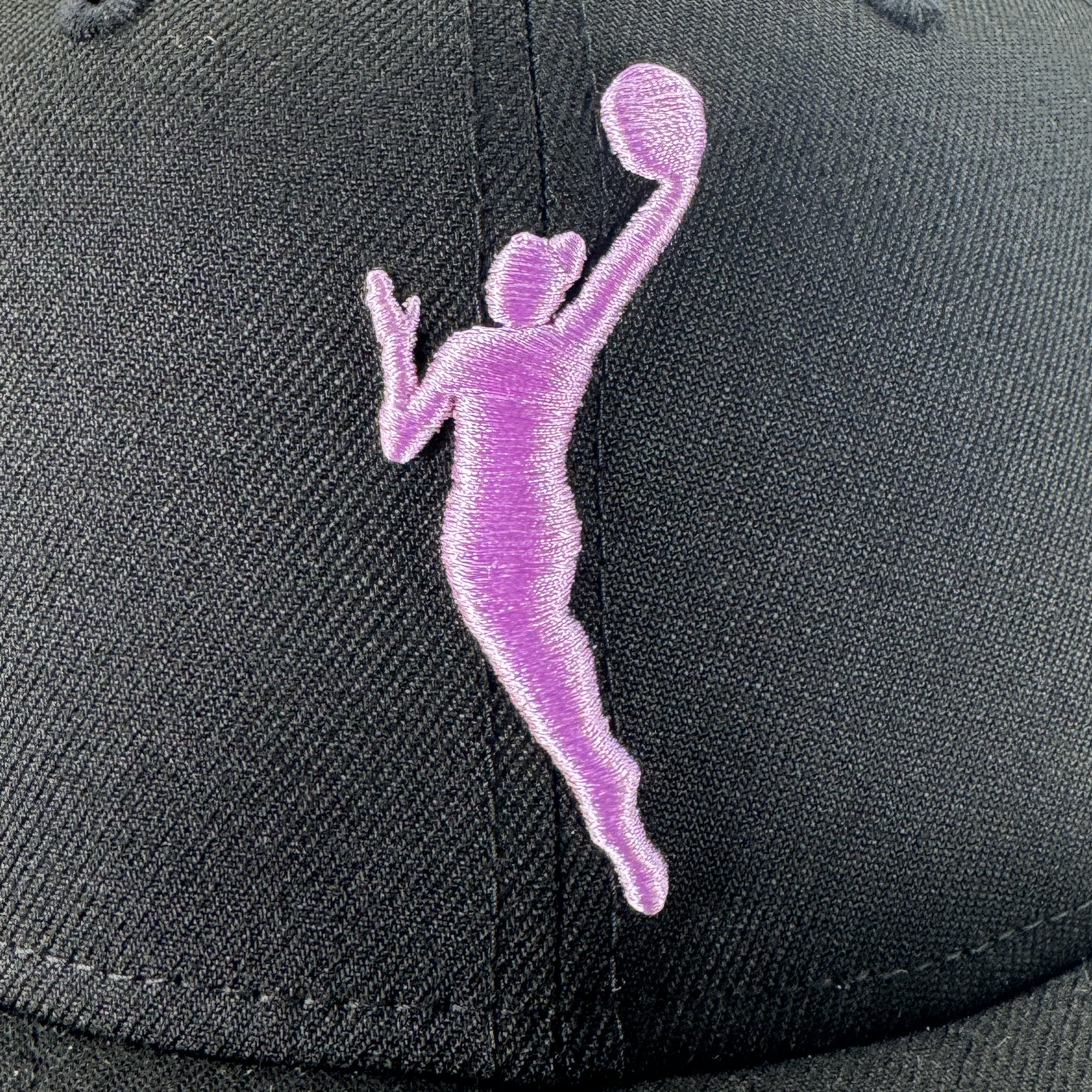 A close-up of the GSV WNBA 9FIFTY Snapback shows a black cap with a pink embroidered basketball player silhouette, neat stitching, and a design reflecting the bold style of GSV.