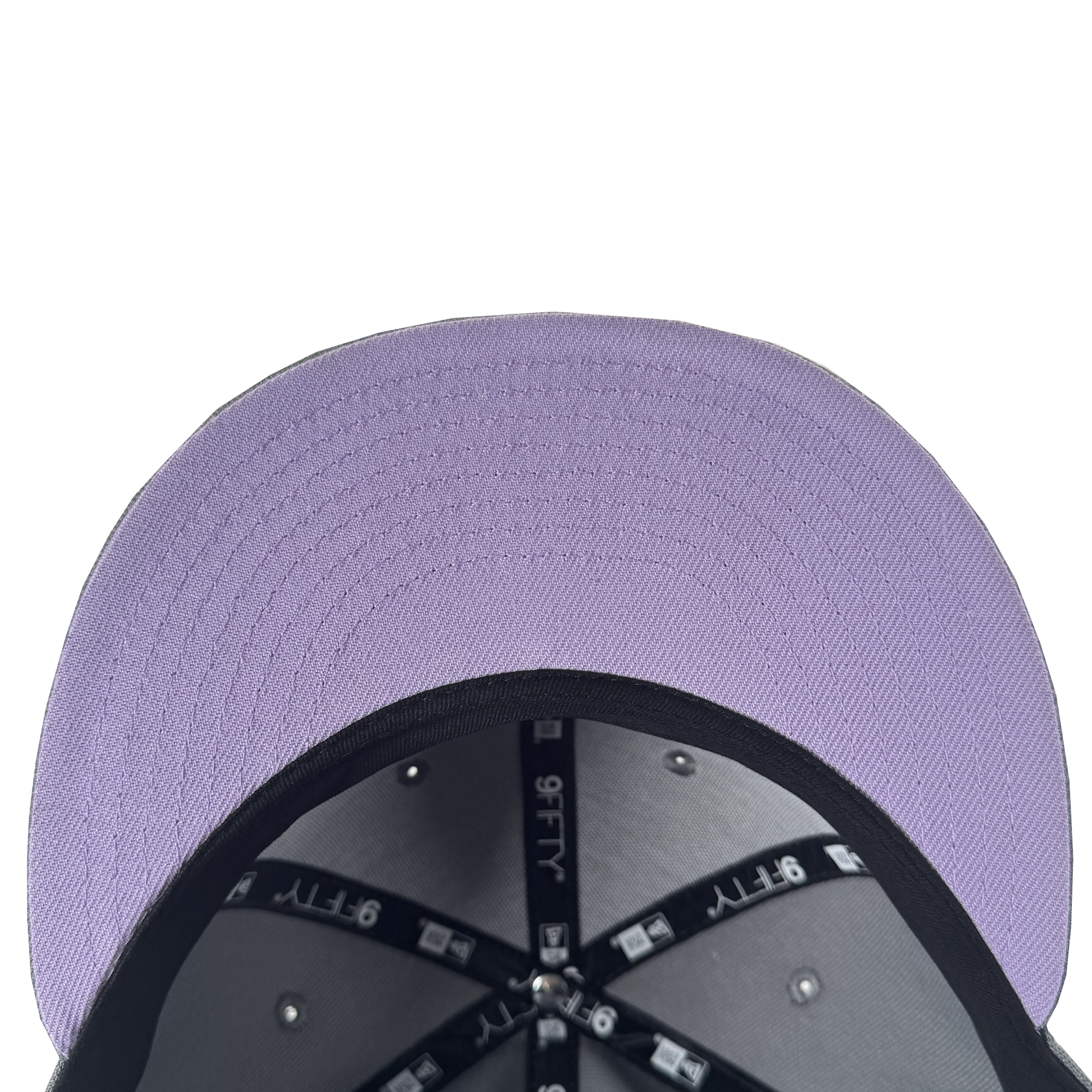 A top-down close-up of the GSV Wordmark 9FIFTY Snapback's purple brim and black interior panels with "9FIFTY" labeled strips and silver rivets, showcased on a white background—ideal for GSV fans.