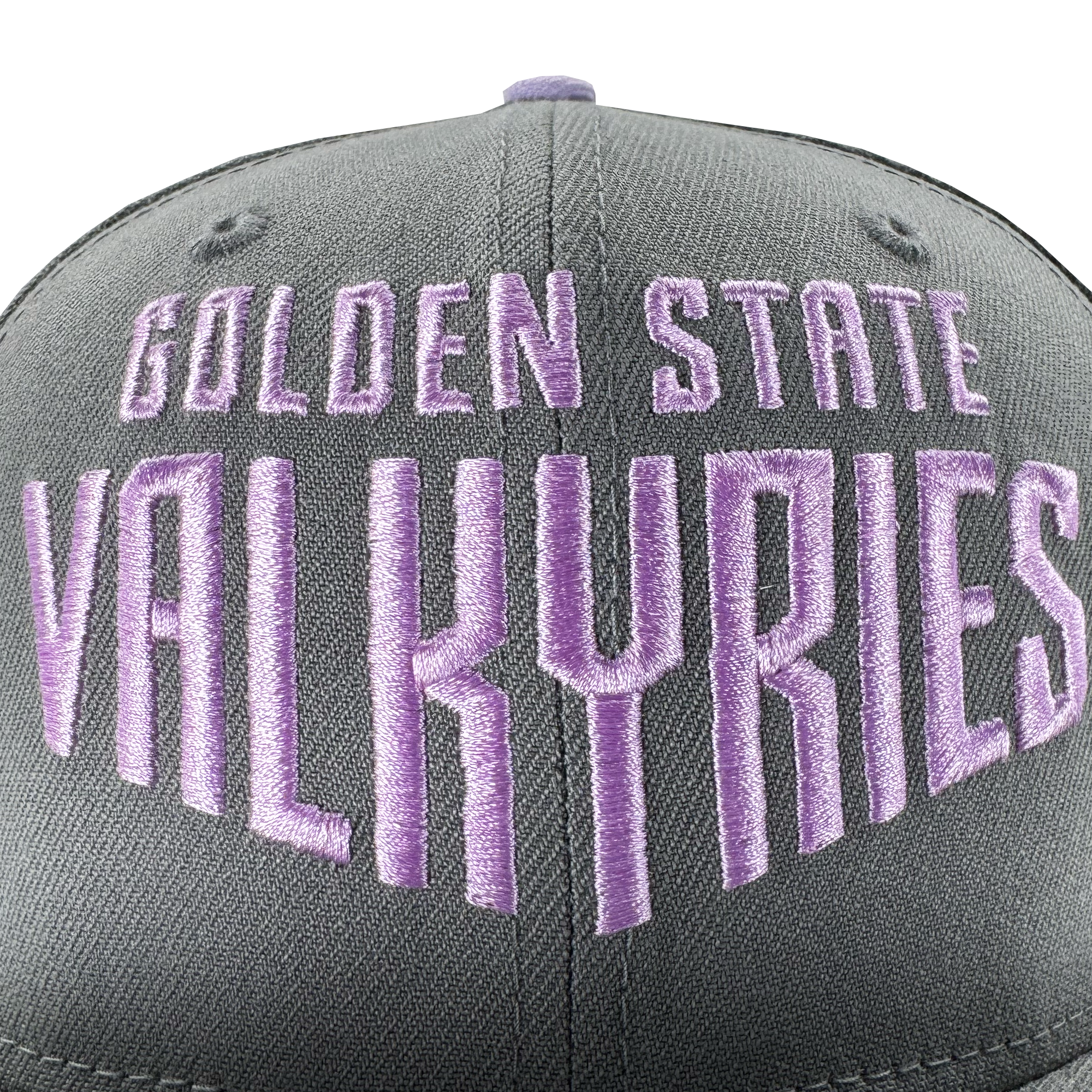 Close-up of a gray GSV Wordmark 9FIFTY Snapback by GSV, featuring bold purple "GOLDEN STATE VALKYRIES" embroidery on the front. Set against a plain white background, the cap’s stitching and fabric texture are clearly visible.