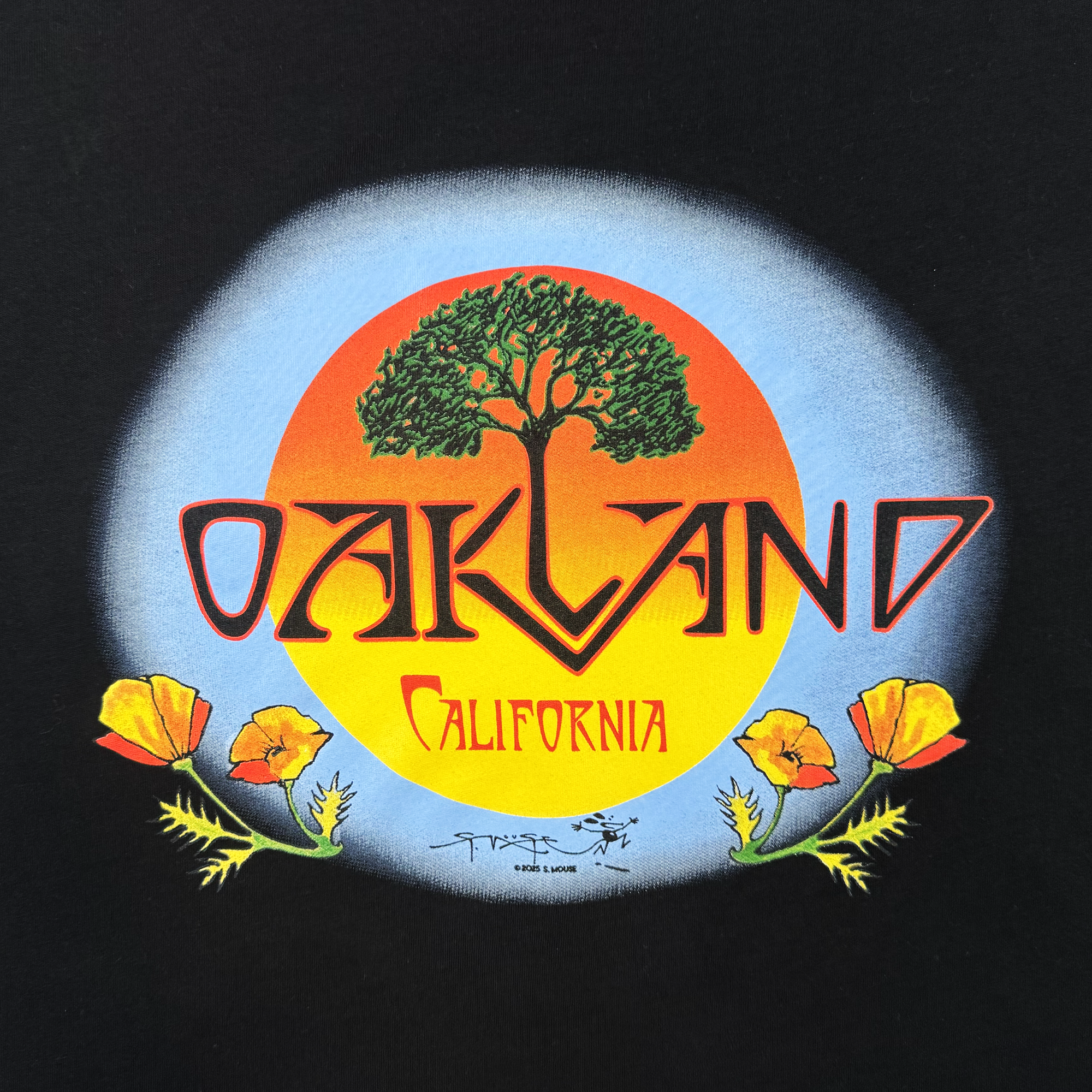 The Women's Vanguard Tee from Oaklandish features a green tree inside an orange-yellow sunburst, "OAKLAND" in bold red below, "CALIFORNIA" in yellow script, and poppy flowers at the corners—art by Stanley Mouse.