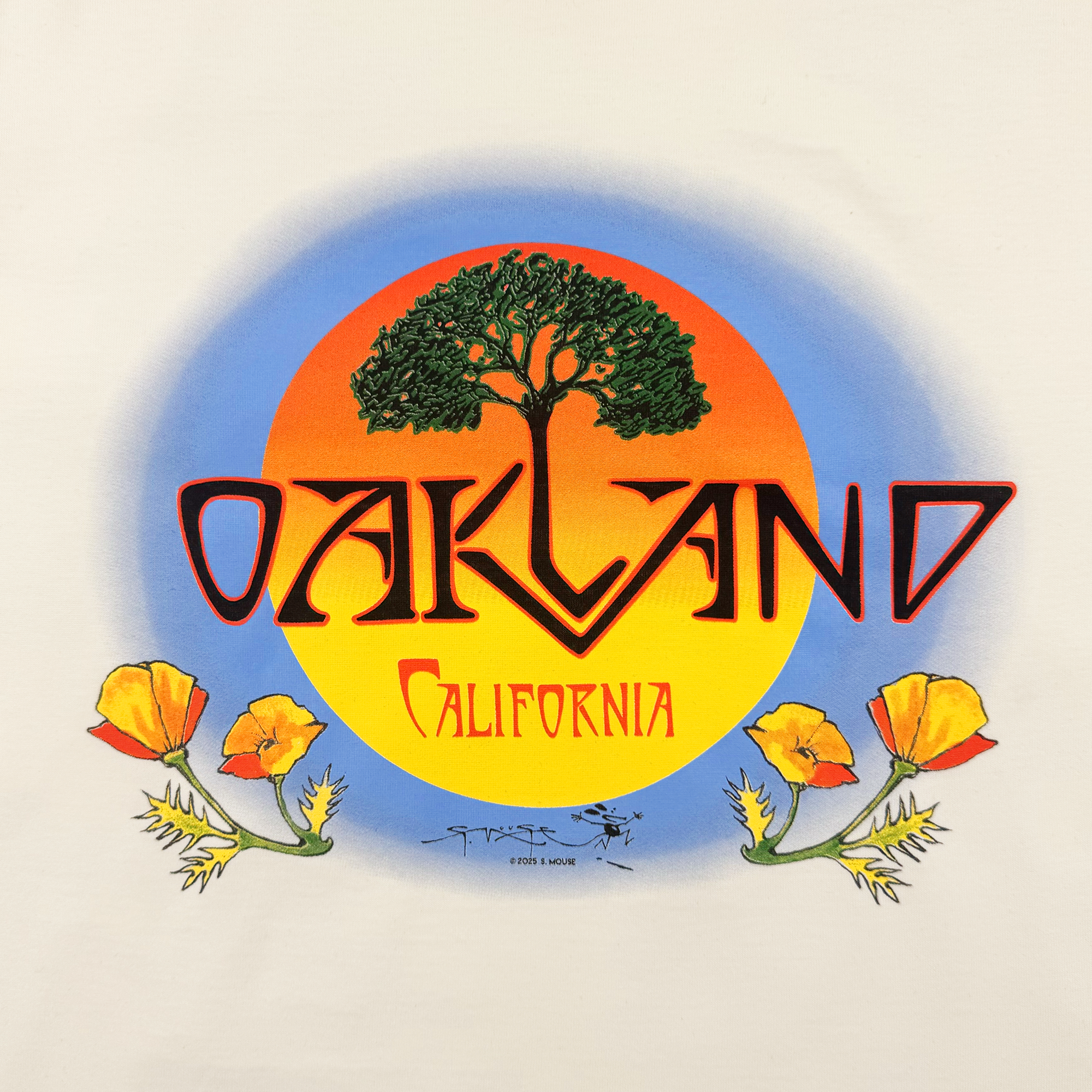 The Oaklandish Vanguard Tee features a bold graphic of a large tree before an orange-yellow sun, blue backdrop, and stylized "OAKLAND California" above poppy flowers, evoking classic tee art with Stanley Mouse-inspired flair.
