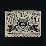 Close-up of intricate lace gold Viva Oakland graphic on the front chest of a black t-shirt.