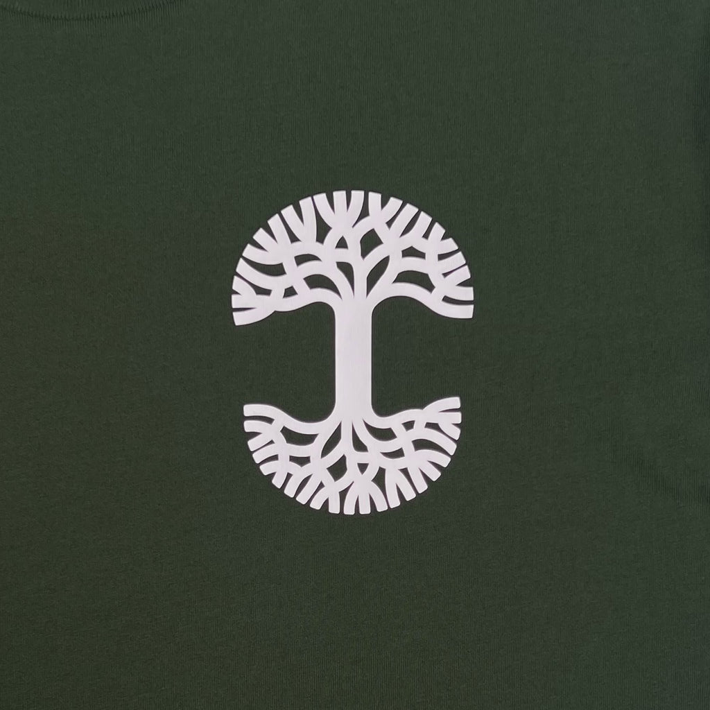 Video of Forest tee with white Oaklandish tree logo transitioning in sun to yellow Oaklandish tree logo.