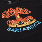 Close up on Oaklandish DJ crew graphic with a turntable, wires & Oaklandish wordmark in orange, yellow, and blue on a black t-shirt.