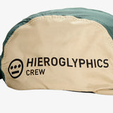 Close-up of khaki side of a baseball cap with Hieroglyphics Crew logo and wordmark.
