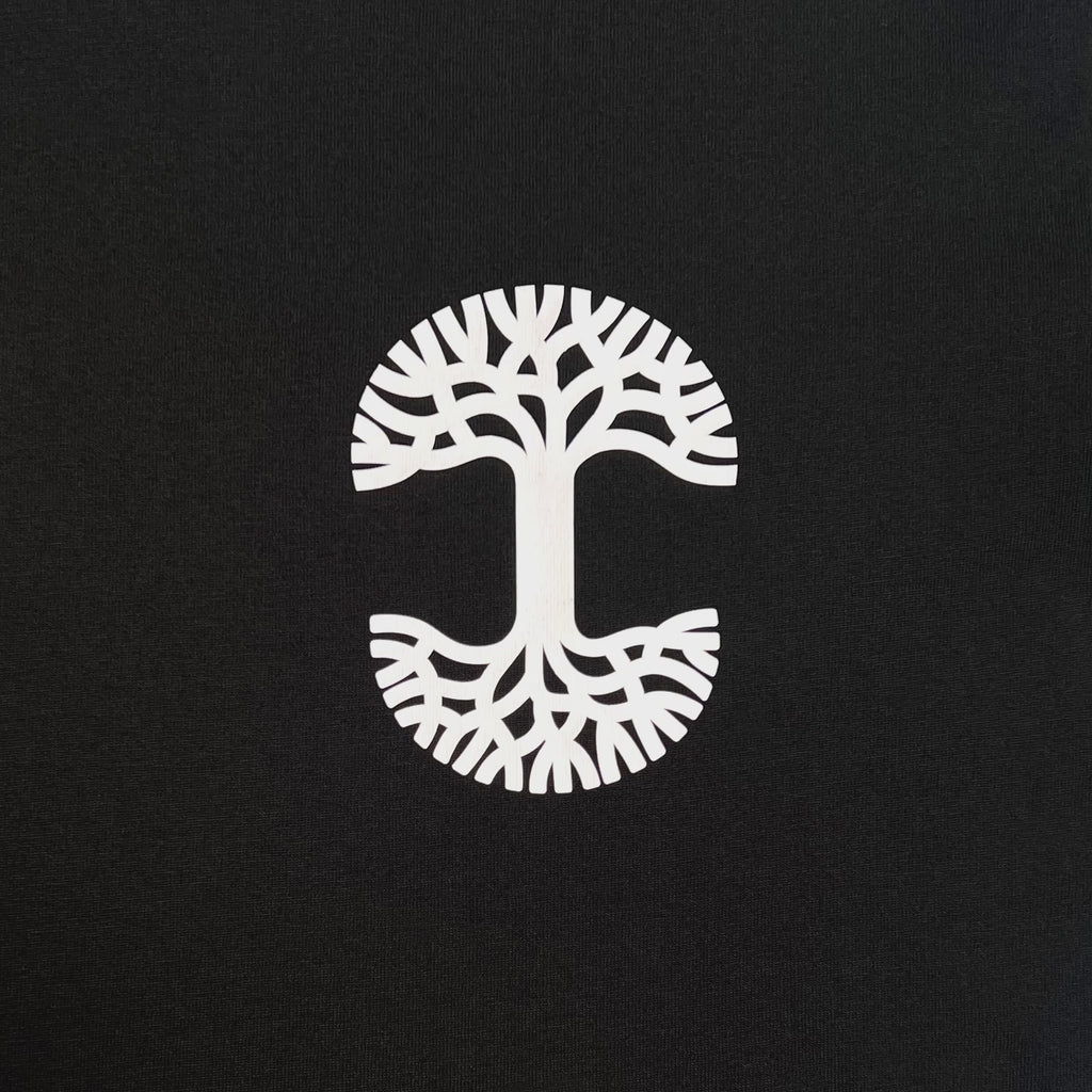 Video of black tee with white Oaklandish tree logo transitioning in sun to magenta Oaklandish tree logo.