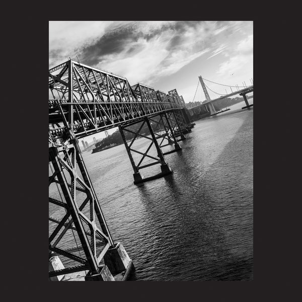 A black women’s cut t-shirt featuring a real-life picture of Oakland’s East Bay bridge.