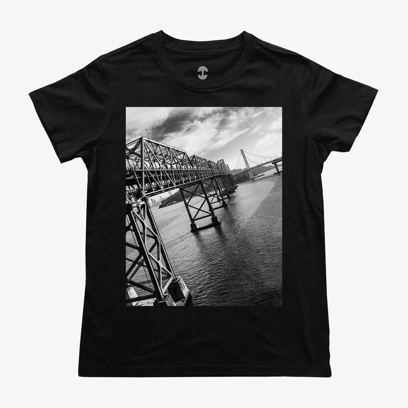 A close up of the picture of Oakland’s East Bay bridge on a women's black t-shirt..