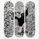 Three black and white skateboard decks with an aerial images of Oakland, Oaklandish logos, and Lake Merritt.