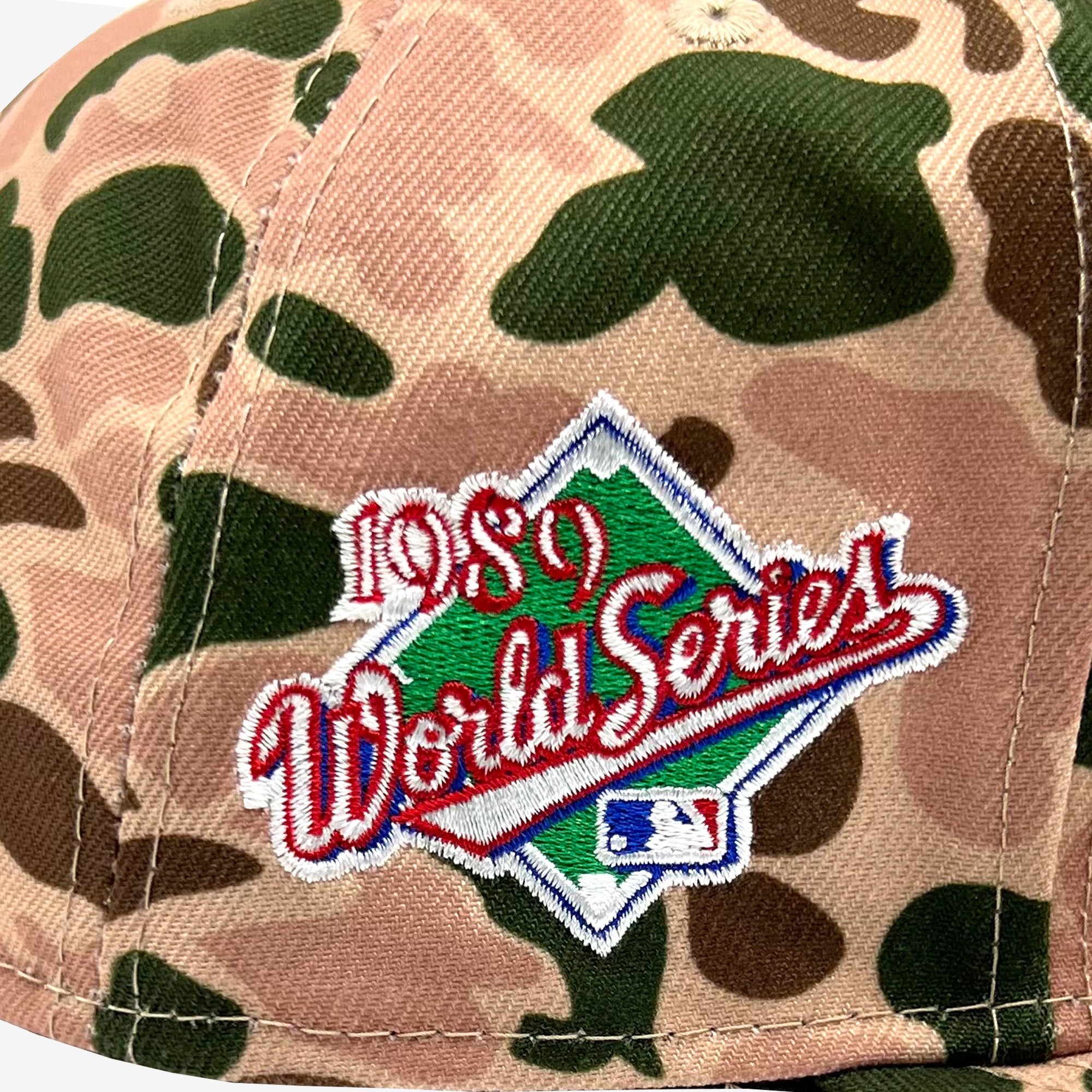 Detailed close-up of 1989 World Series embroidered patch on the side of a duck camo cap.
