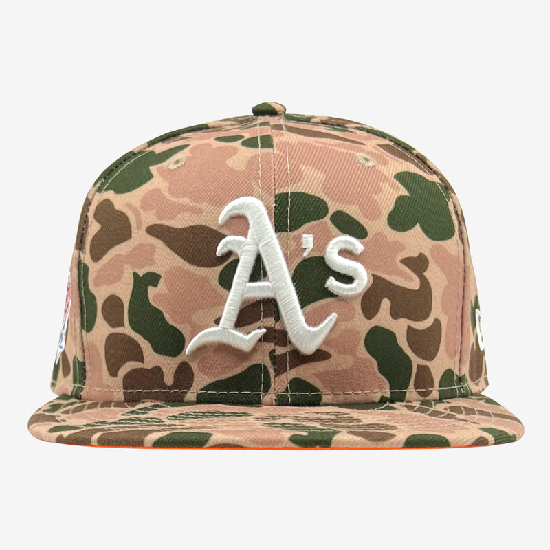 Front view of duck camo cap with an embroidered As logo on the crown.