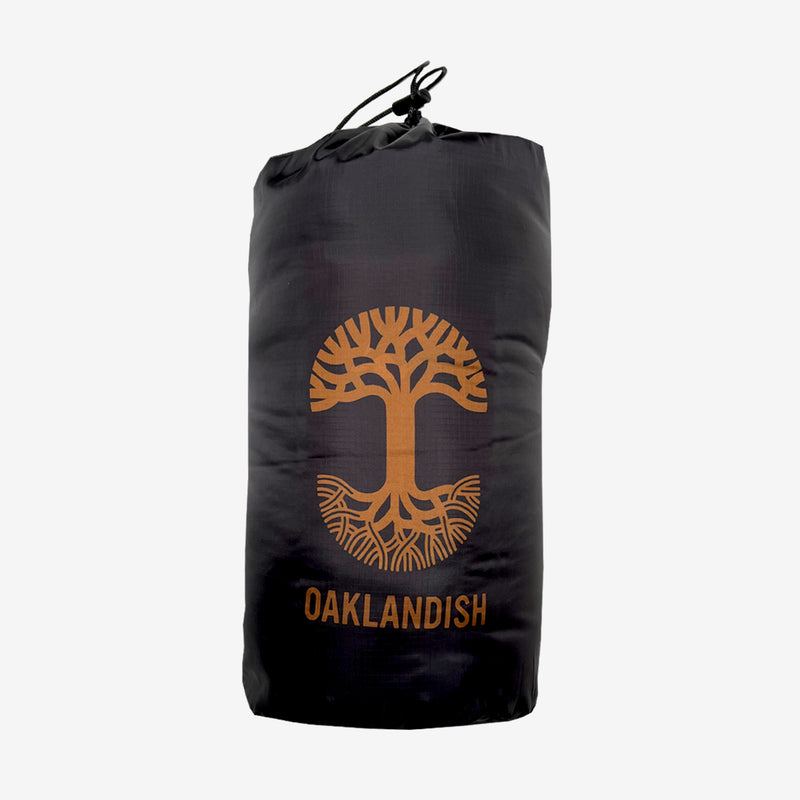 Black blanket stuff sack with rust colored Oaklandish tree logo on the front.