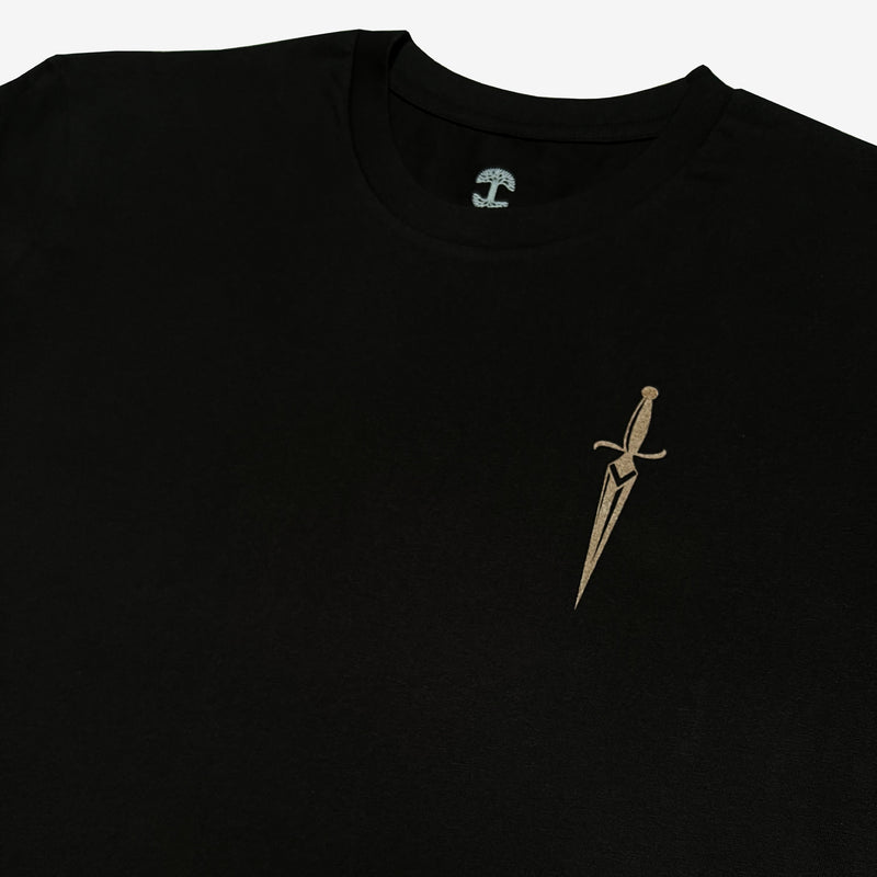 Close-up of sword graphic on the front chest of a black cotton t-shirt.
