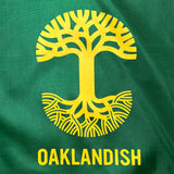 Detailed close-up image of forest drawstring bag with yellow Oaklandish logo imprinted on front.