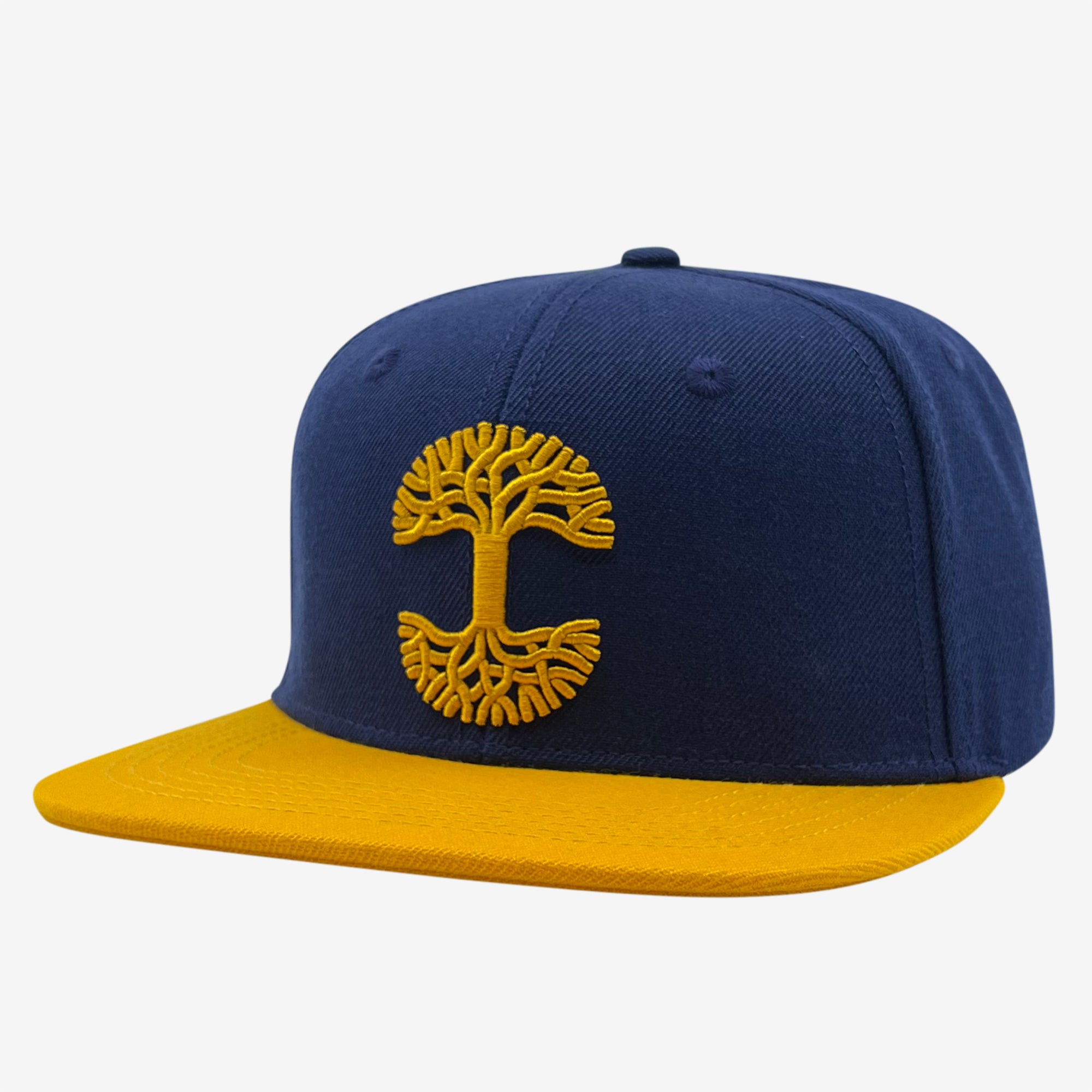 Side view of royal blue snapback hat with yellow embroidered Oaklandish tree logo on crown and contrasting yellow visor.