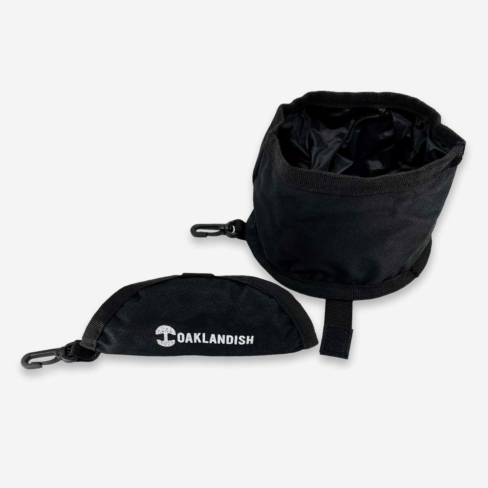 Black collapsable pet travel water bowl with white Oaklandish wordmark and tree logo on the carry bag.