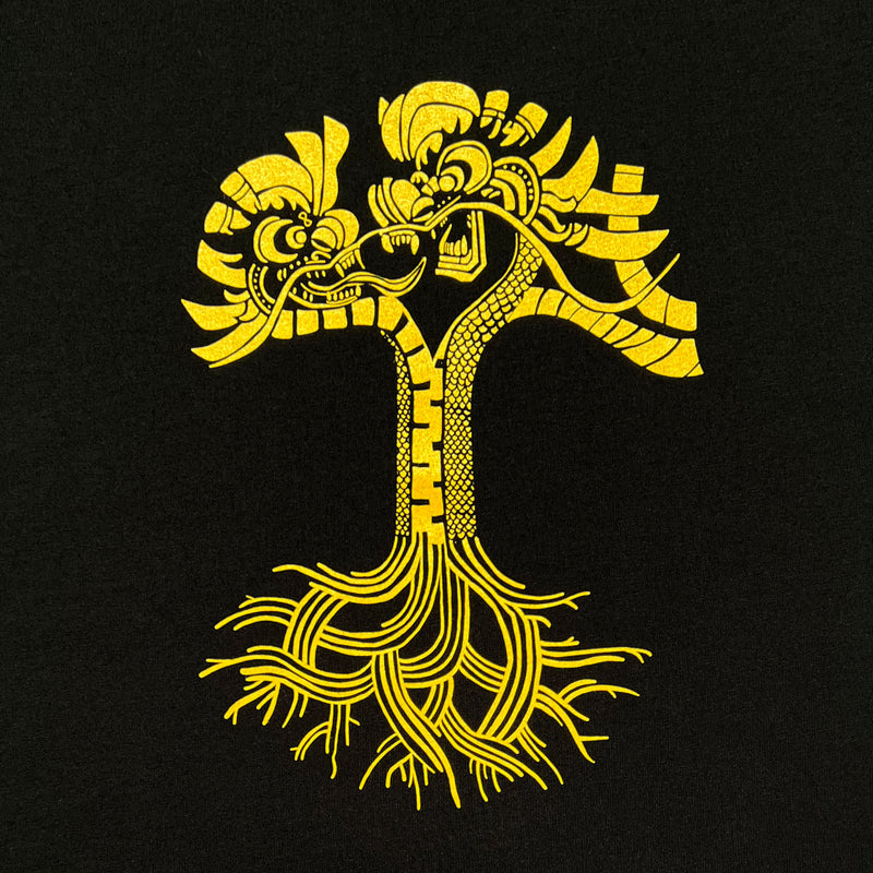 Close-up of gold dragon power graphic design in the shape of an Oaklandish tree logo on a black women’s t-shirt.