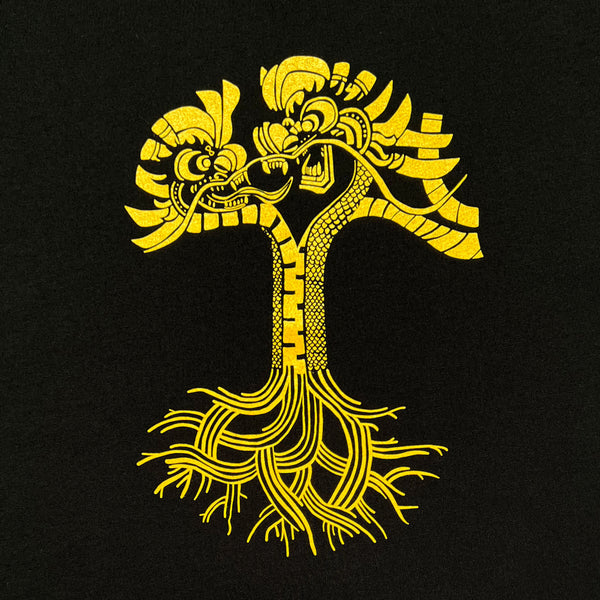 Close-up of gold dragon power graphic design in the shape of an Oaklandish tree logo on a black t-shirt.