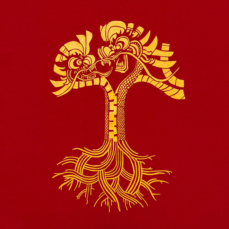 Close-up of gold dragon power graphic design in the shape of an Oaklandish tree logo on a red t-shirt.