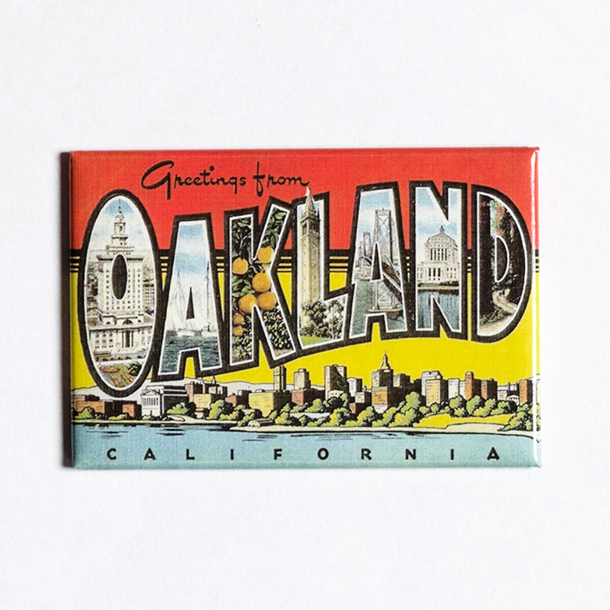 The Greetings from Oakland Magnet by Oaklandish is a vintage postcard-style refrigerator magnet that prominently displays "Greetings from Oakland, California" in bold letters. The word "OAKLAND" features images of local landmarks and scenes within each letter, set against a gradient background that transitions from red at the top to yellow and green at the bottom. The word "California" is positioned at the bottom.