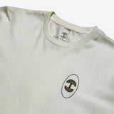 Close up of black Oaklandish tree logo in black oval circle on natural cotton t-shirt.