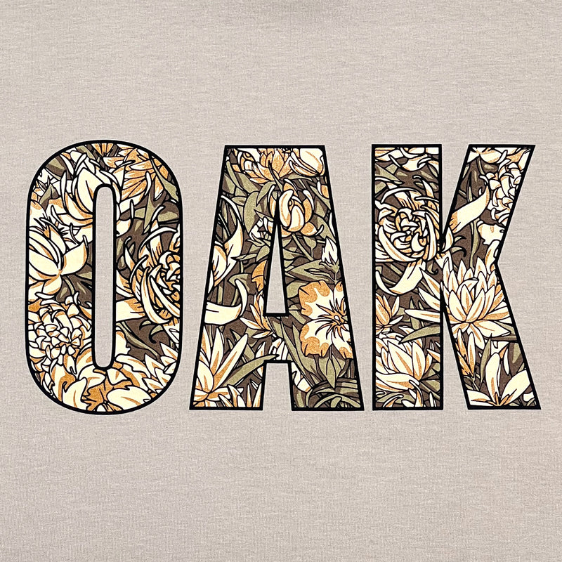 Detailed close-up image of men's bone t-shirt with floral pattern inside 'OAK' wordmark.