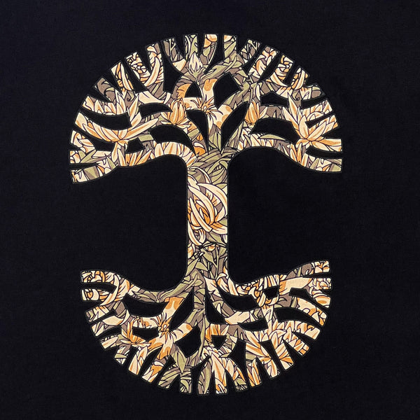 Detailed close-up image of men's black t-shirt with floral pattern inside classic Oaklandish tree logo.
